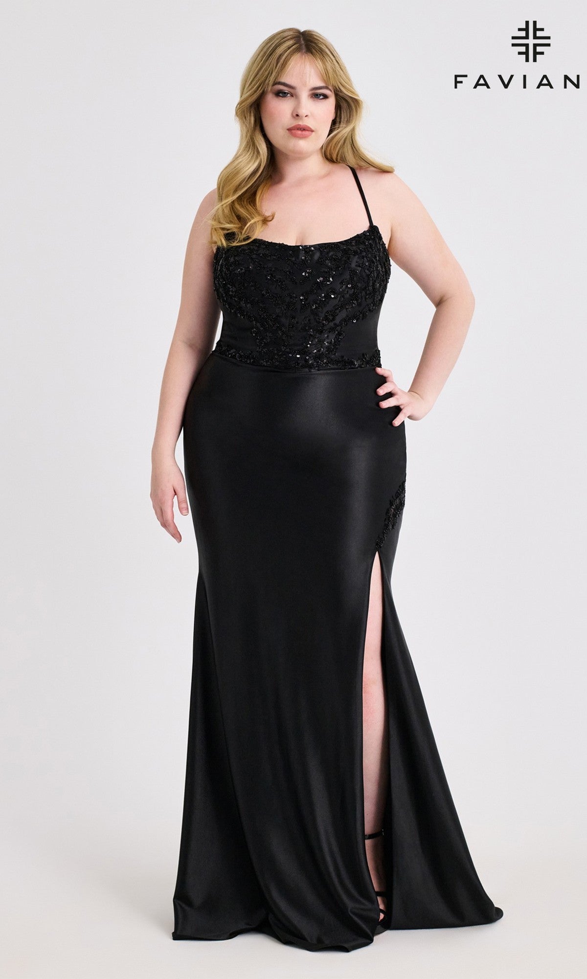 A woman in a black, lace-up plus-size long prom dress (Faviana 9606) with a beaded corset and satin skirt stands against a plain background. Faviana's logo appears in the top right corner.